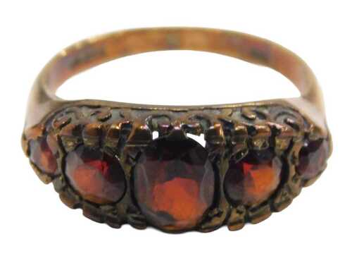 A 9ct gold garnet dress ring, set with five oval cut garnets, each claw set, ring size P, 3.4g...