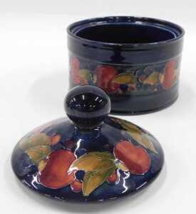 A Moorcroft pottery Pomegranate pattern jar and cover, with circular knop, on blue ground, 15cm... - 2