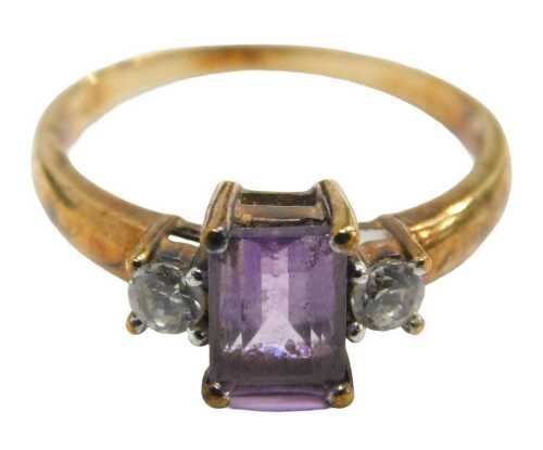 A 9ct gold amethyst and CZ dress ring, set with rectangular cut amethyst in a raised basket,...