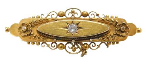 A Victorian 15ct gold bar brooch, with filigree and scroll bar, centred by a round brilliant cut...