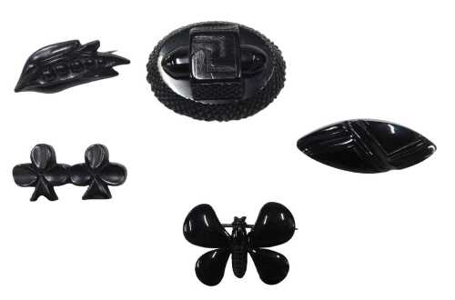 Five jet and imitation jet brooches, comprising an oval carved raised jet brooch, 5cm x 3cm, and...