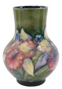 A Moorcroft pottery Anemone pattern vase, of bellied circular form on circular foot, on green...