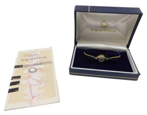 A Certina 9ct gold ladies wristwatch, the small silvered dial with baton and numeric border, on...