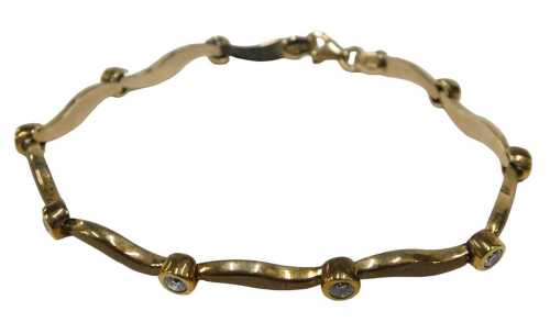 A 9ct gold tennis bracelet, with waved brushed links, separated by tiny diamonds in rub over...