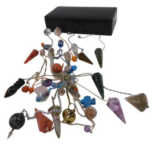 A group of hardstone pendants, to include orange and green agate, clear crystal, amethyst and...