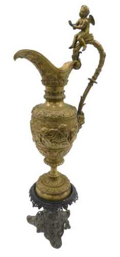 A 19thC Grand Tour style gilt metal ewer or claret jug, with part reeded handle, surmounted by a...