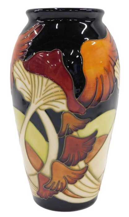 A Moorcroft pottery Parasol Dance pattern shouldered vase, on blue ground, 19cm high.