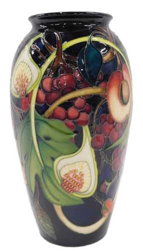 A Moorcroft pottery Queen's Choice pattern vase, of tapering shouldered form, on blue ground,...
