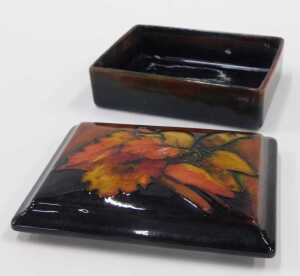 A Moorcroft pottery flambe box and cover, 6cm high. - 2