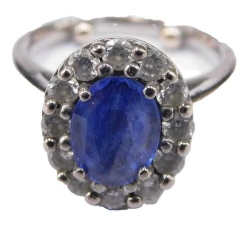 A sapphire and diamond dress ring, with central oval cut cornflower blue sapphire, 8.4mm x 6.2mm...
