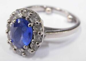 A sapphire and diamond dress ring, with central oval cut cornflower blue sapphire, 8.4mm x 6.2mm... - 2