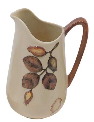 A Carlton ware pottery jug, decorated with leaves in relief, 23cm high, various costume...
