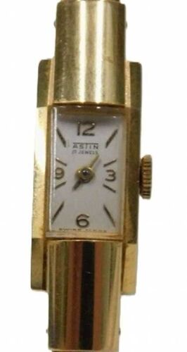 An Astin ladies 18ct gold cocktail watch, with modern curbed bangle finish, with a white enamel...