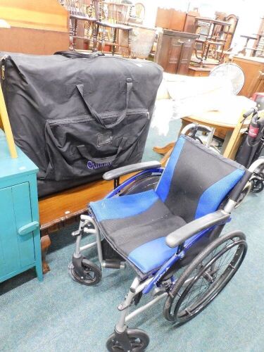 A piecrust edge coffee table, wheelchair and massage table.