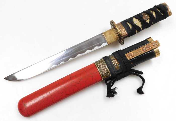 A 20thC Japanese Tanto, the tsuka wrapped in ray skin, and bound with cord, the copper habaki...