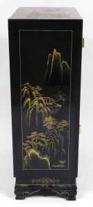 A Chinese lacquered cabinet, gilt decorated with river landscapes, having two doors opening to... - 4