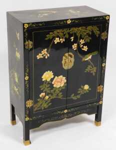 A Chinese black lacquer cabinet, of rectangular section, painted with birds, trees in blossom,...