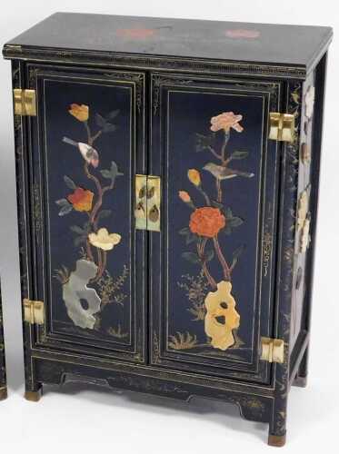 A Chinese black lacquer cabinet, of rectangular form, decorated with flowers, and overlaid in...
