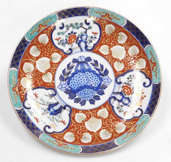 A late 20thC Japanese Imari charger, decorated with reserves of trees and prunus blossom, and...