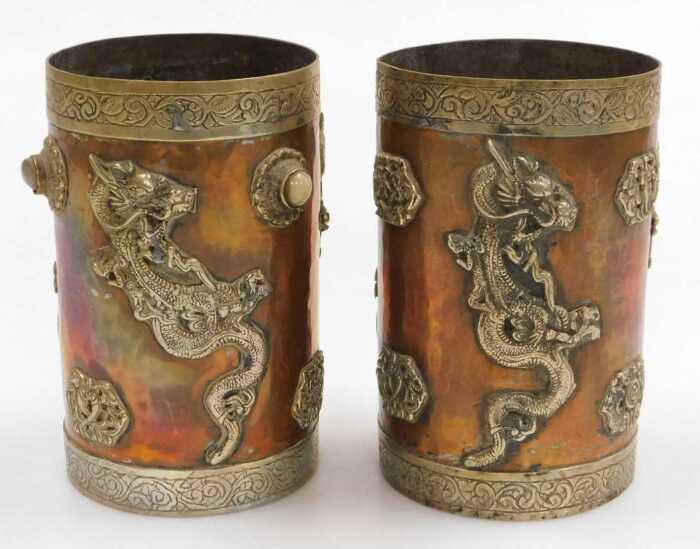 Two early 20thC Oriental copper vessels, of cylindrical form, applied in white metal with...