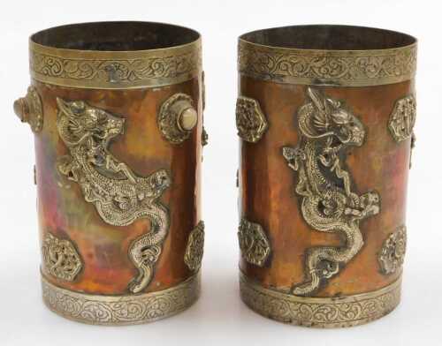 Two early 20thC Oriental copper vessels, of cylindrical form, applied in white metal with...