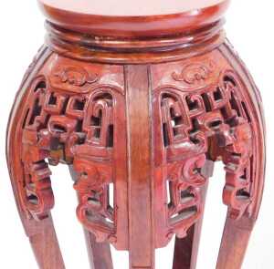 A pair of Chinese hardwood urn stands, stained red, each with a plain circular top, above... - 3