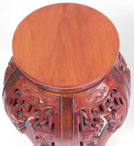 A pair of Chinese hardwood urn stands, stained red, each with a plain circular top, above... - 4