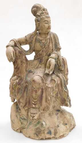A Qing Dynasty 19thC Chinese wooden figure of Guanyin, modelled seated upon a rocky base,...