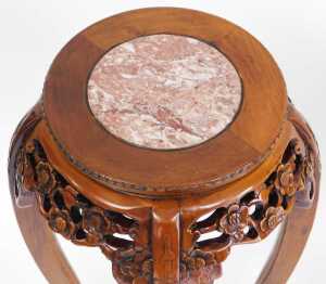 A pair of Chinese hardwood urn stands, the circular top inset with red marble, above a prunus... - 4