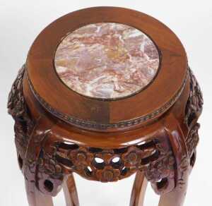 A pair of Chinese hardwood urn stands, the circular top inset with red marble, above a prunus... - 7