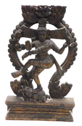 A 20thC Nataraja carved wooden sculpture of Lord Shiva, balanced on a dwarf Apasmara holding a...