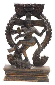 A 20thC Nataraja carved wooden sculpture of Lord Shiva, balanced on a dwarf Apasmara holding a...