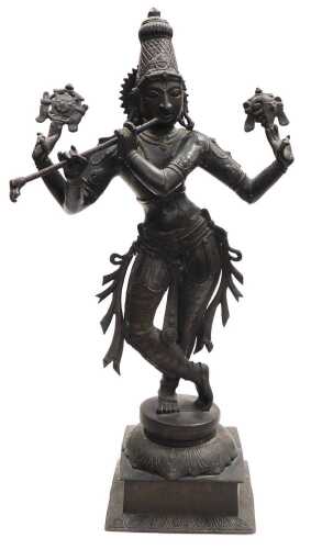 A 20thC bronze figure of Lord Krishna, modelled standing, in a cross legged pose, playing a...
