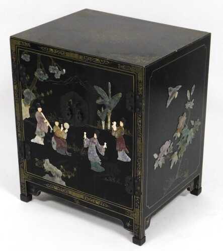 A Chinese black lacquered cupboard, of rectangular form, with floral and foliate scroll...