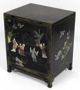 A Chinese black lacquered cupboard, of rectangular form, with floral and foliate scroll...