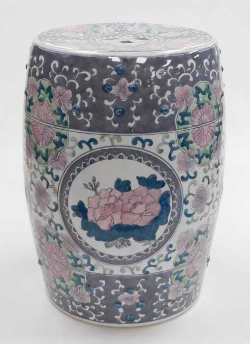 A late 20thC Chinese porcelain garden seat, of barrel form, decorated with reserves of flowers...