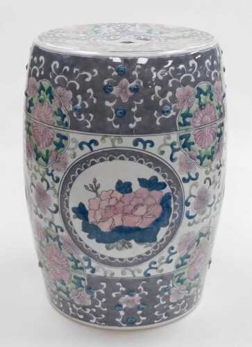 A late 20thC Chinese porcelain garden seat, of barrel form, decorated with reserves of flowers...