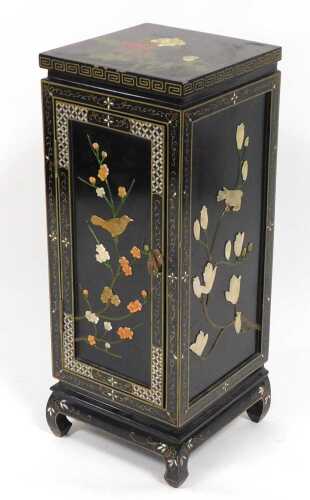 A Chinese black lacquered side cupboard, of square form, decorated with flowers, the sides...