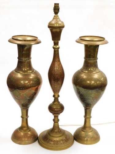 A 20thC Indian brass table lamp, highlighted in red and embossed with flowers, together with a...