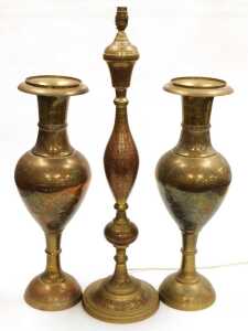 A 20thC Indian brass table lamp, highlighted in red and embossed with flowers, together with a...