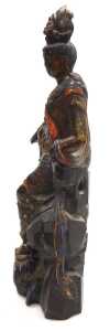 A Qing Dynasty late 19thC carved hardwood figure of Guanyin, modelled seated on a rocky base,... - 2