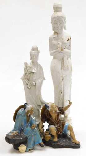 A 20thC Chinese blanc de chine figure of Guanyin, modelled standing holding a lotus flower, 37cm...