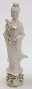 A 20thC Chinese blanc de chine figure of Guanyin, modelled standing holding a lotus flower, 37cm... - 2