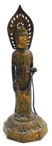 A late 19thC gilded cast iron figure of Guanyin, modelled standing, raised on an octagonal lotus...
