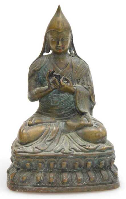 A 19thC Tibetan bronze figure of a Lama Tsongkapa, modelled seated in a lotus flower position,...