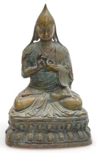 A 19thC Tibetan bronze figure of a Lama Tsongkapa, modelled seated in a lotus flower position,...