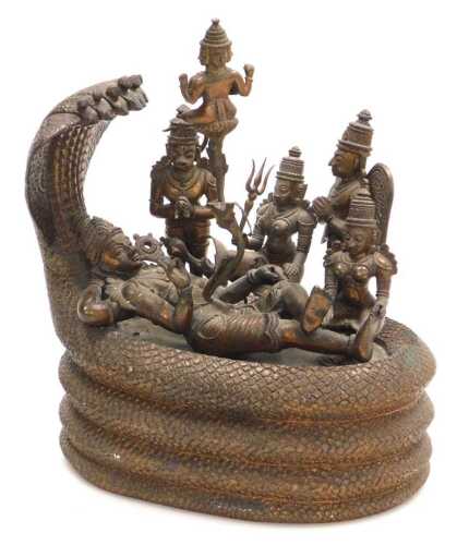 A 19thC Indian copper alloy figure group, depicting the Cosmic Sleep of Lord Vishnu, modelled...