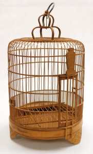 A Chinese bamboo bird cage, of cylindrical form, with a crown surmount, raised on three scroll...