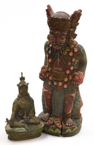 A Tibetan brass figure of Padmasambhava, modelled seated on a lotus flower base, 22cm high,...