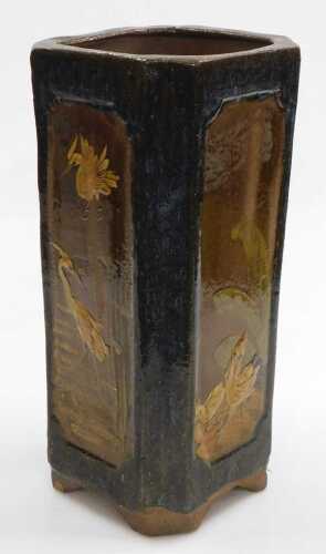 An early 20thC Chinese vase, of canted square form, relief decorated with panels of birds, on a...